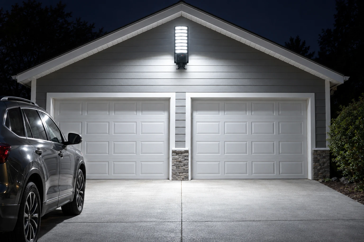 Solar street light mounted above a garage at night